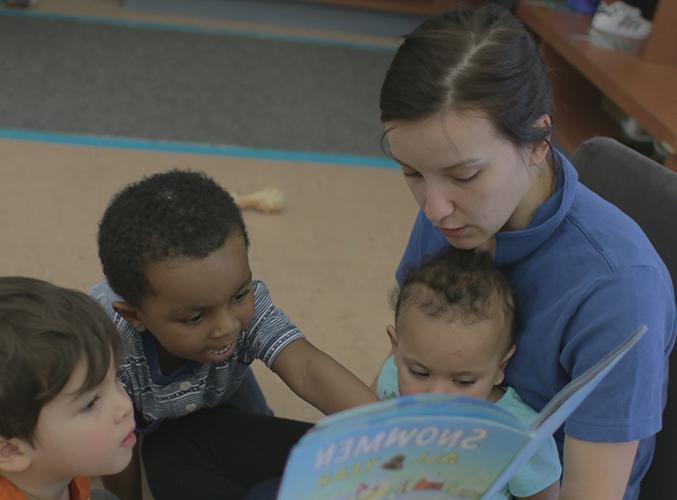 FDC staff member reading book to children